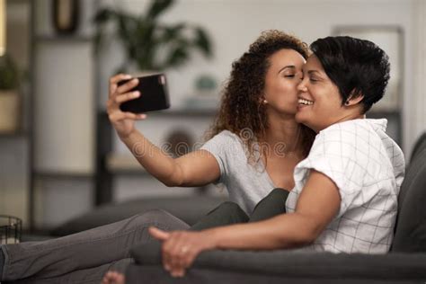 capturing all our memories a lesbian couple taking a selfie of the couch at home stock image