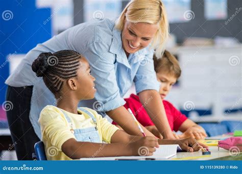 Teacher Help Student In Class Stock Photo Image Of Teacher Helping