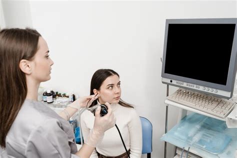 Premium Photo Ent Doctor Using Fibrolaryngoscope To Examine And Treat