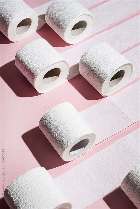Several Rolls Of Toilet Paper On A Pink Surface