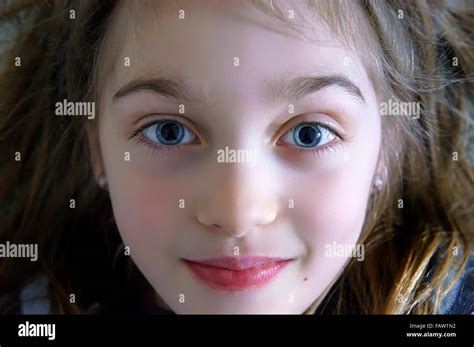 Beautiful Smiling Young Girl With Big Blue Eyes Looking At Camera Close