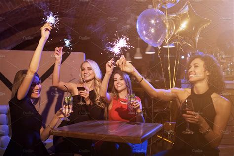 Group Of Female Friends Enjoying Birthday Party Having Fun With