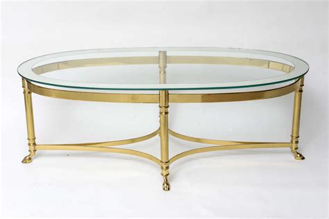 Glass top oval brass coffee table: Oval Brass Coffee Table with Mirrored Rim Glass Top at 1stdibs