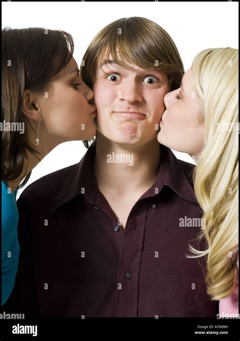 Boy Being Kissed On Both Cheeks By Two Girls Stock Photo Alamy