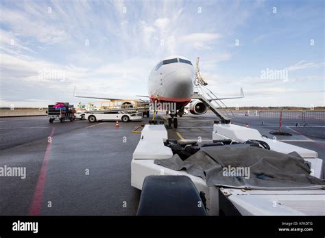 Towing Truck With Commercial Airplane On Airport Runway Stock Photo Alamy