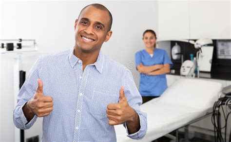 Man Client Giving Thumbs Up In Aesthetic Medicine Clinic Stock Image