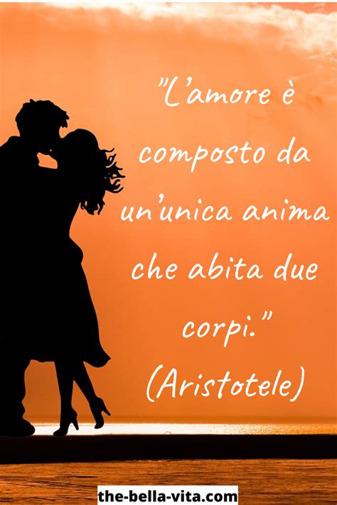 A Couple Kissing In Front Of An Orange Sky With The Words I Amore E