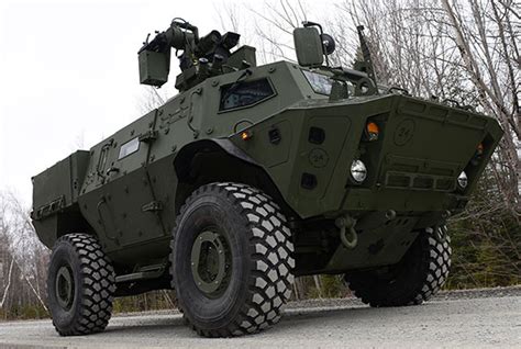 An Armored Vehicle Driving Down The Road