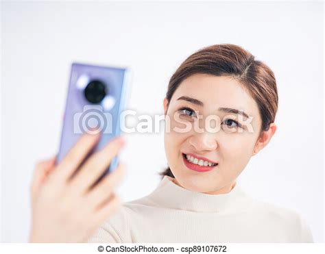 Young Women Take Self Portraits With Mobile Phones Young Smiling Women