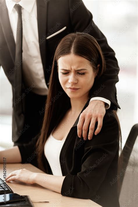 Sexual Harassment At Work Male Businessman Puts Hand On Annoyed Female