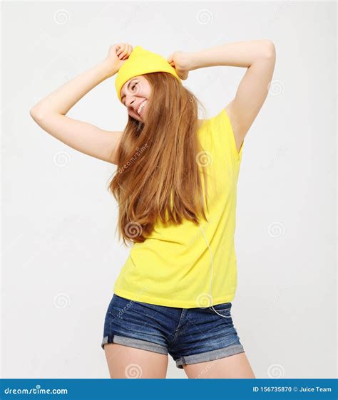 Girl In Yellow T Shirt Dancing With Inspired Face Expression Stock
