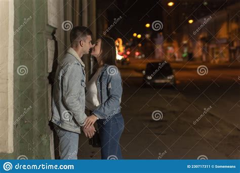 Guy Is Eager To Kiss His Girlfriend Young Loving Couple On The Street Evening Date In City