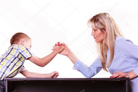 Mother And Son Arm Wrestle Sit At Table Stock Photo By ©voyagerix