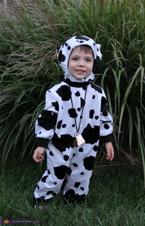 She made a little body suit jumper out of a cow print material with velcro to hold the back of the costume shut. Homemade Cow Costume
