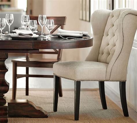 Slightly curved brown wing back contrasts with straight tapered legs in a printed woodgrain finish, our accent chair not only provides you a good place to relax and rest, but also adds a hint of retro and chic to your space. Thayer Tufted Wingback Dining Chair | Pottery Barn