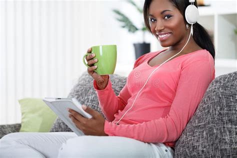 Photo About Smiling Black Woman Relaxing With Music And Tea At Home