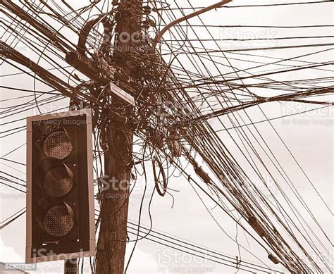 Messy Electrical Cables On Electric Pole Behind The Traffic Lights