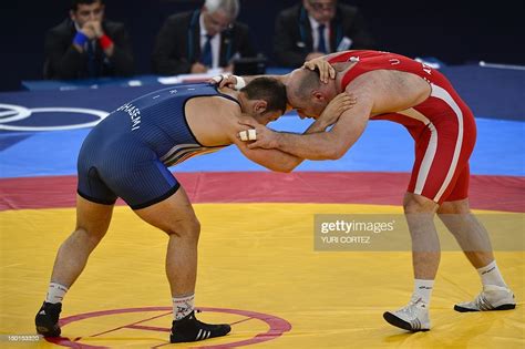 Uzbekistans Artur Taymazov Wrestles Irans Komeil Ghasemi In Their