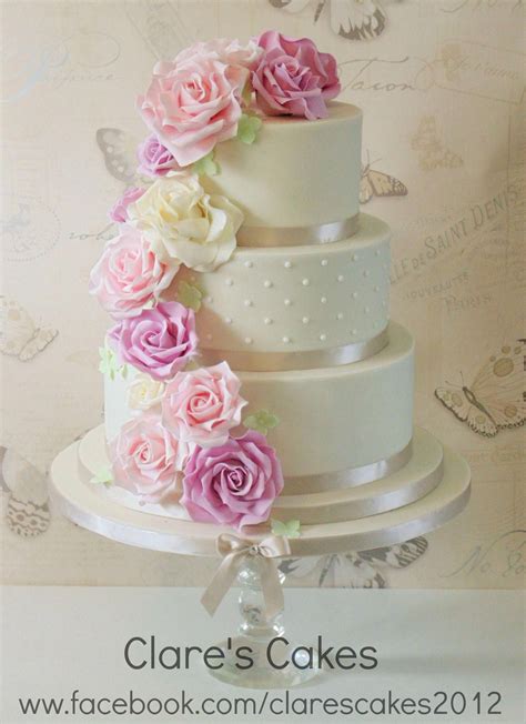Ivory Wedding Cake With Pink Lilac And Ivory Roses Cascading Down The