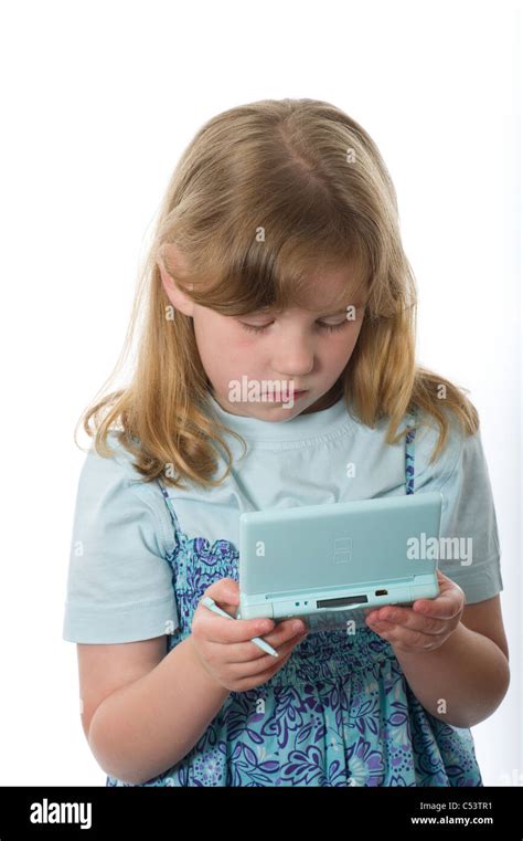 Young Girl Of Primary Age Playing On A Nintendo Ds Game Console Shot