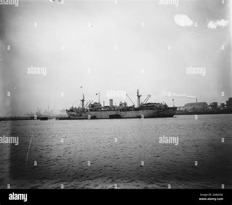 Various Naval Ships Are Anchored Together Around A Freighter Date 25