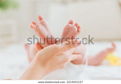 Mothers Hand Holds Babys Legs Mother Stock Photo 2214241127 Shutterstock
