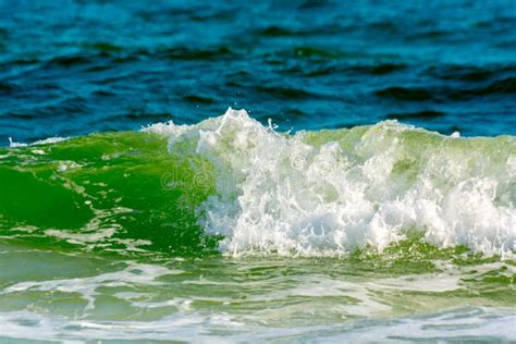 Green Ocean Wave On Blur Blue Ocean Water Background Stock Image