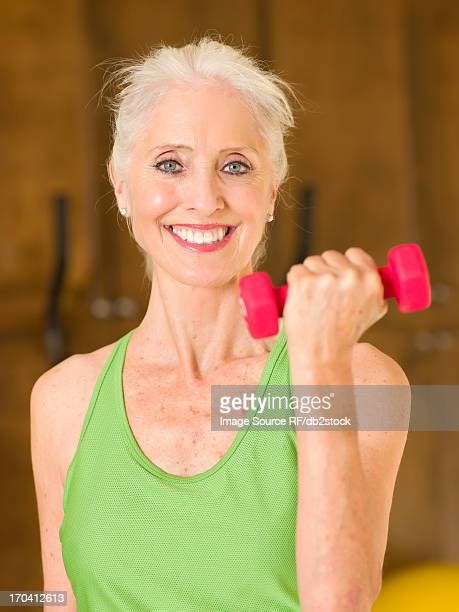 Woman Flexing Bicep At Home Photos And Premium High Res Pictures