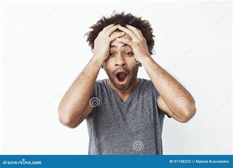 Portrait Of Surprised And Shocked African Man With Opened Mouth Finding Out He Missed A Sale Or