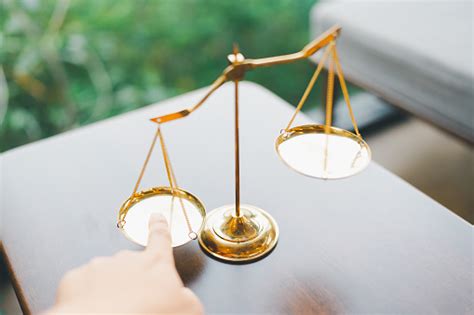Tip The Scales Of Justice Concept As A The Hand Of A Person Illegally