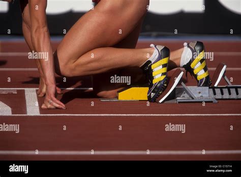 Detail of female sprinter in the starting blocks Stock Photo - Alamy