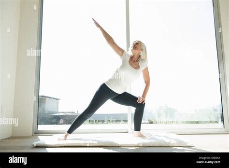 Senior Woman In Yoga Pose Arm Raised Stock Photo Alamy