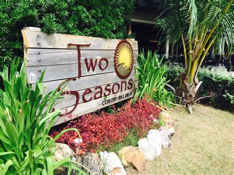 Two Seasons Resort Sign Surrounded By Tropical Plants