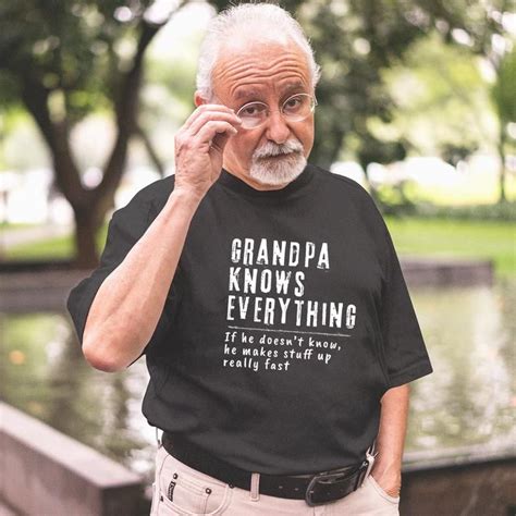 An Older Man Talking On A Cell Phone While Wearing A T Shirt That