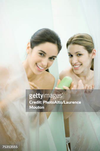 Two Young Women Taking Showers One Handing The Other A Bar Of Soap High