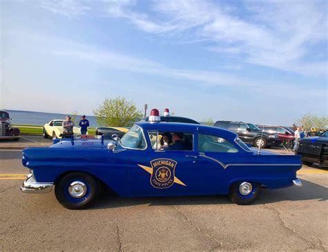 An Old Police Car Parked In A Parking Lot