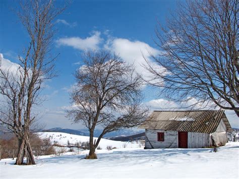 Sunny Winter Day With Snow And Mountain Lonely Cottage Stock Photo