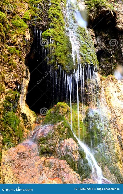 Cave Entrance Hidden Behind A Small Waterfall Stalactite Cave In The