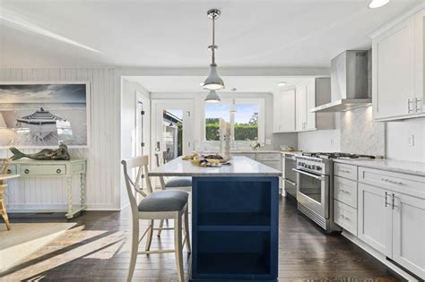 For your blue kitchen cabinets to work out great, you must mix and match them properly with other colors in the room. Coastal White Kitchen with Navy Island | Blue kitchen designs, Small kitchen decor, White ...