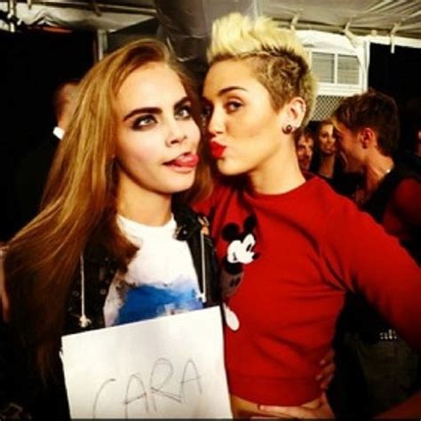 Photo Of The Day Miley Cyrus Gives Supermodel Cara Delevingne Some Tongue