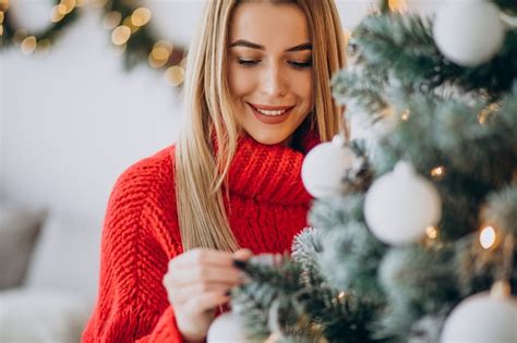 Free Photo Young Woman Decorating Christmas Tree