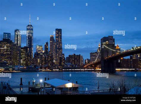 The Lower Manhattan Skyline And The Brooklyn Bridge As Seen Across The