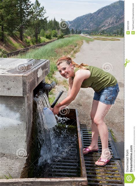 Teen Getting Spring Water Royalty Free Stock Images