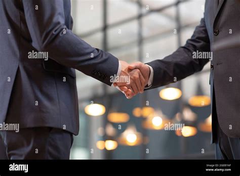 Successful Chinese Businessmen Shaking Hands In Office Stock Photo Alamy