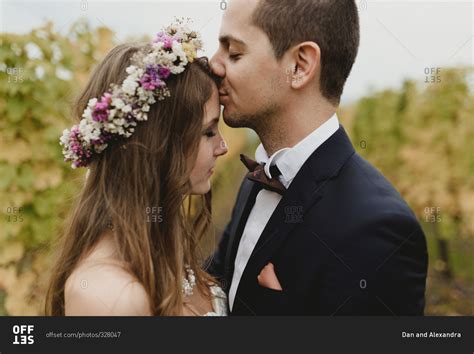 Groom Kissing His Brides Forehead In A Vineyard Stock Photo Offset