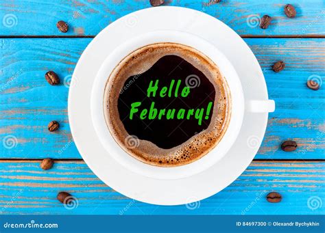 Hello February Inscription On Top Viewed Coffee Cup On Blue Wooden