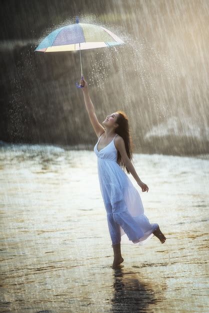 Premium Photo Pretty Young Woman With Rainbow Umbrella Under Summer Rain