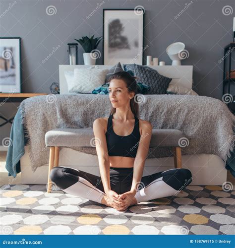 Young Woman Stretches Her Legs With Her Knees Apart Stock Image