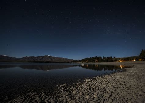 Lake Tekapo At Night Stars Above The Perfect Smooth Lake Surface And