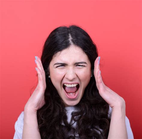 Portrait Of Angry Girl Screaming Against Red Background Stock Image